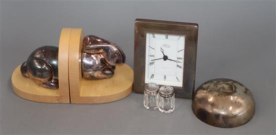 A quantity of mixed silver including a modern pair of rabbit bookends, a mounted timepiece, sugar bowl and two peppers.